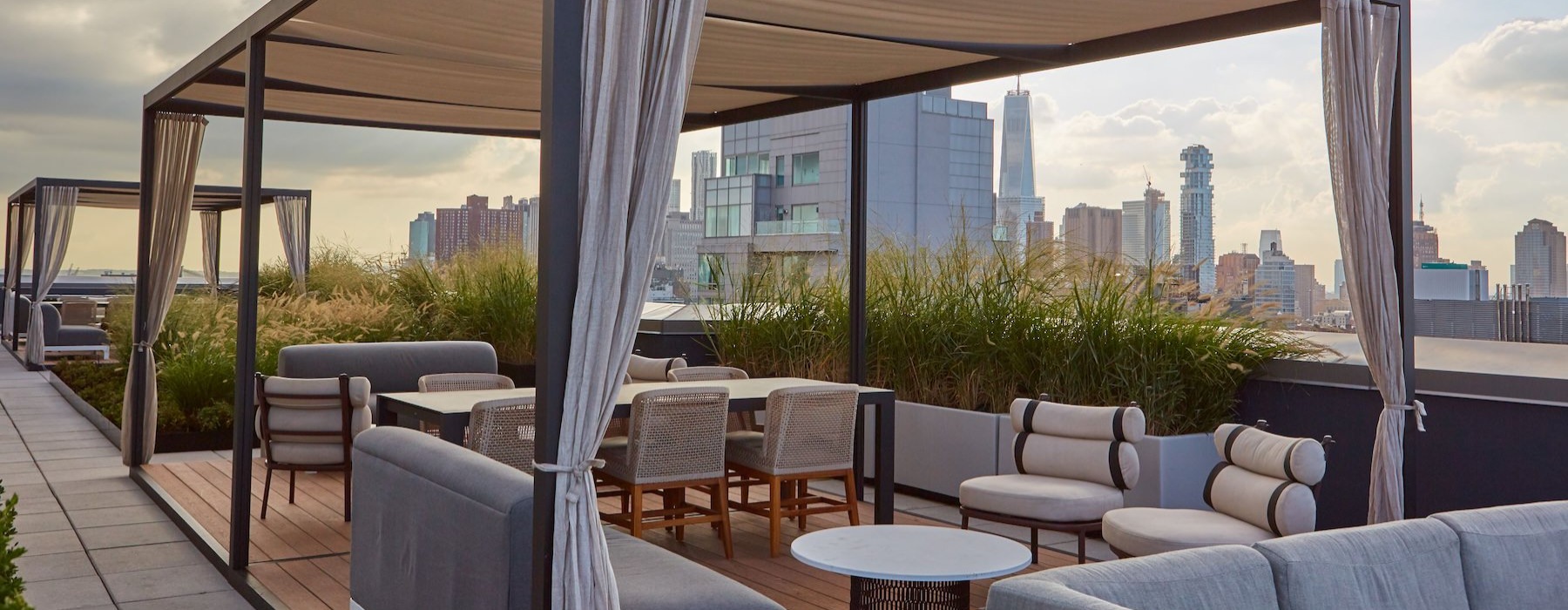 a lounge with a tent, tables, chairs and couches