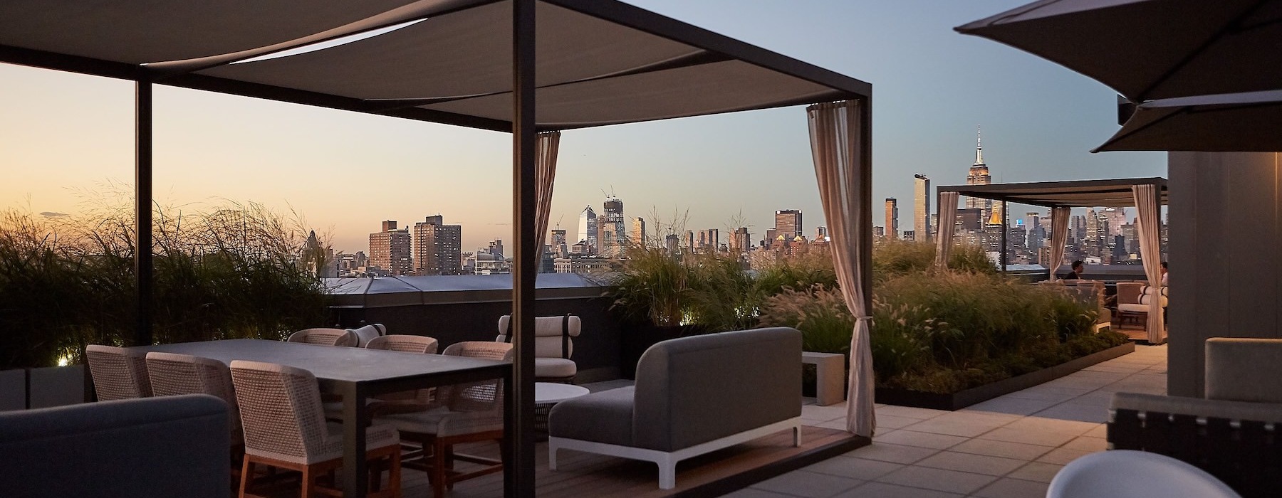 a lounge with a tent, tables and chairs